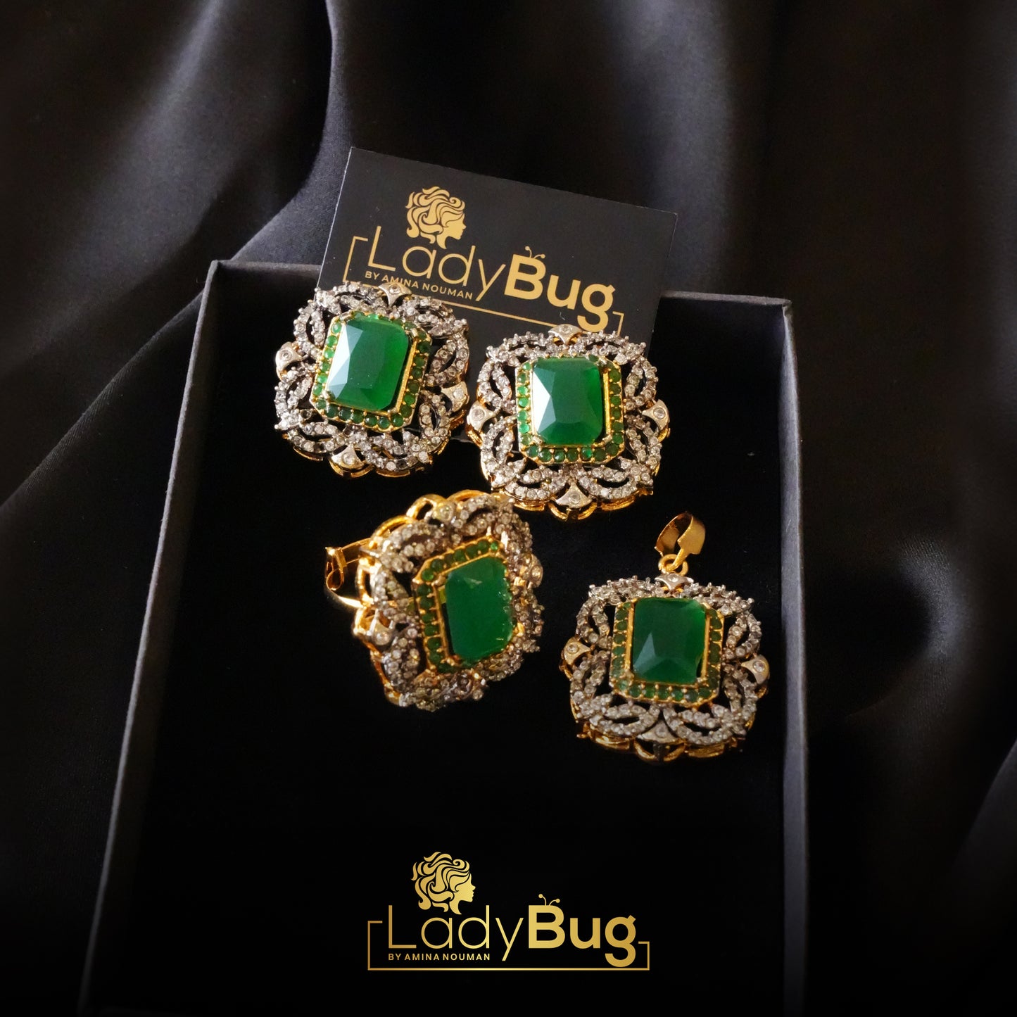 gold-plated diamond cut pendant set with emerald stones